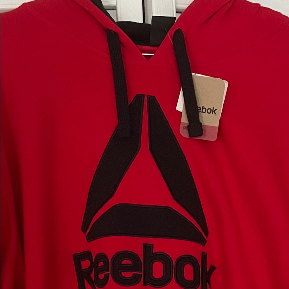 Red Reebok hoodie.